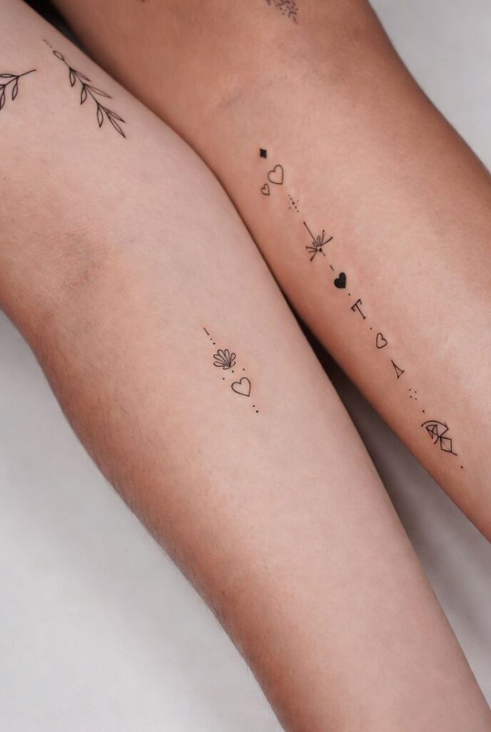 Minimalist Symbol Tattoos for Women Fine Line Heart Icon Forearm Tattoo Ideas Minimalist line art tattoos of hearts and geometric shapes on two arms, showcasing delicate designs and fine linework. | Sky Rye Design Minimalist line art tattoos of hearts and geometric shapes on two arms, showcasing delicate designs and fine linework.