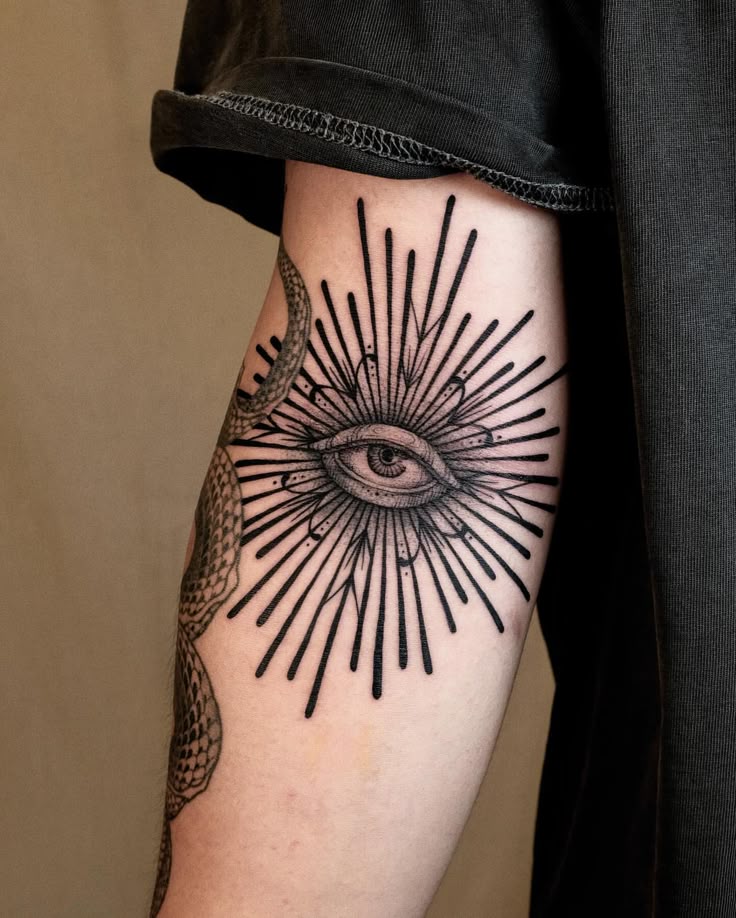 Open your Third eye 👁️ Look around new world Arm tattoo featuring an eye with radiant lines in black ink. Artistic design symbolizes watchfulness and spiritual insight. | Sky Rye Design Arm tattoo featuring an eye with radiant lines in black ink. Artistic design symbolizes watchfulness and spiritual insight.