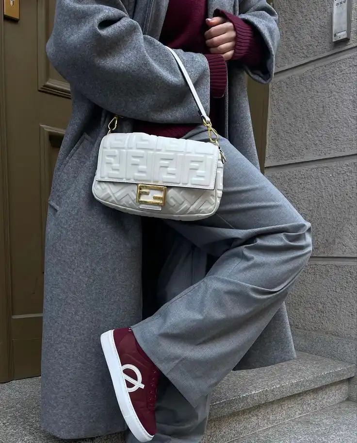 Stylish outfit with grey coat, burgundy sweater, white designer bag, and maroon sneakers, perfect for a trendy street look.