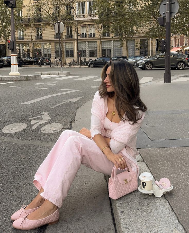 Parisian streets make me so happy🥹🫶🏼🥐__parisstyle pinkgirls pinterestinspo pinterestgirls Woman in pink outfit sitting on a city curb, holding a pink bag with coffee and pastries beside her, in an urban street setting. | Sky Rye Design Woman in pink outfit sitting on a city curb, holding a pink bag with coffee and pastries beside her, in an urban street setting.