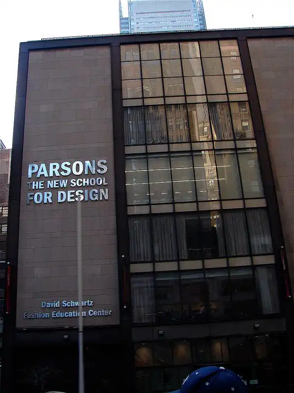Parsons School of Design building facade, New York City, showcasing modern architectural style and educational banner in urban setting.