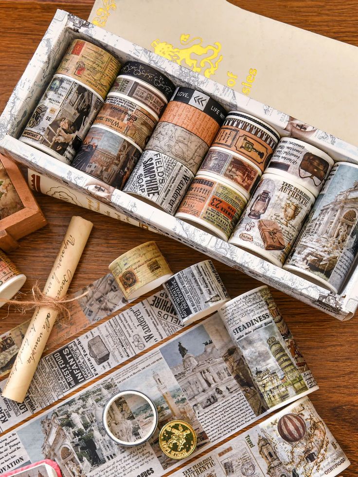 Retro Washi Tape Box Set 1824 Rolls for Journaling Creative Decor - 250224-1 Decorative vintage-style washi tape set with historical, newspaper, and travel-themed designs displayed in a box on a wooden surface. | Sky Rye Design Decorative vintage-style washi tape set with historical, newspaper, and travel-themed designs displayed in a box on a wooden surface.