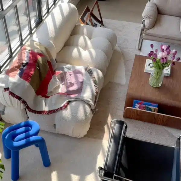 Screenshot_2025-03-03_at_114314_am_600x600 Modern living room with white sofa, colorful throw, tulips on wooden coffee table, and unique blue chair in natural light. | Sky Rye Design Modern living room with white sofa, colorful throw, tulips on wooden coffee table, and unique blue chair in natural light.