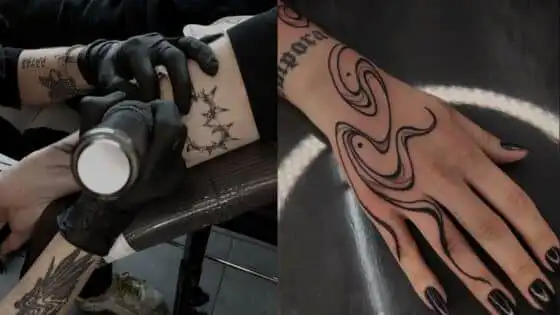 Tattoo artist inks forearm with gloves; hand displays intricate black tattoo design, creating a striking contrast with dark nails.