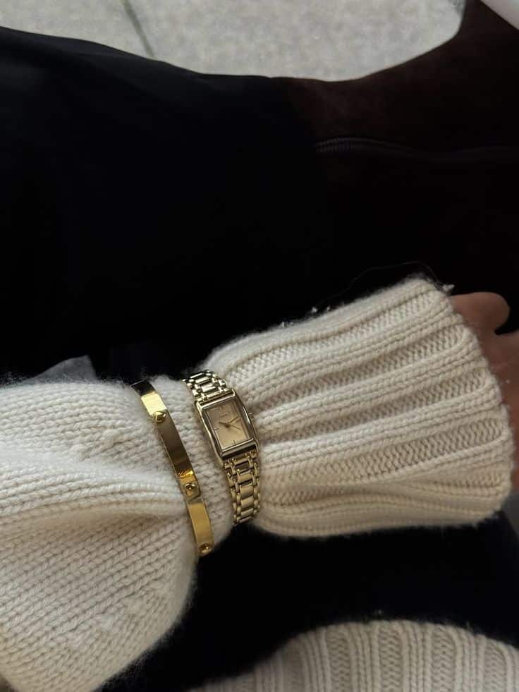 Styling Gold Jewelry with Winter Knits ✨ Cozy white sweater with a gold watch and bracelet on wrist, stylish and elegant, perfect for a chic winter fashion look. | Sky Rye Design Cozy white sweater with a gold watch and bracelet on wrist, stylish and elegant, perfect for a chic winter fashion look.
