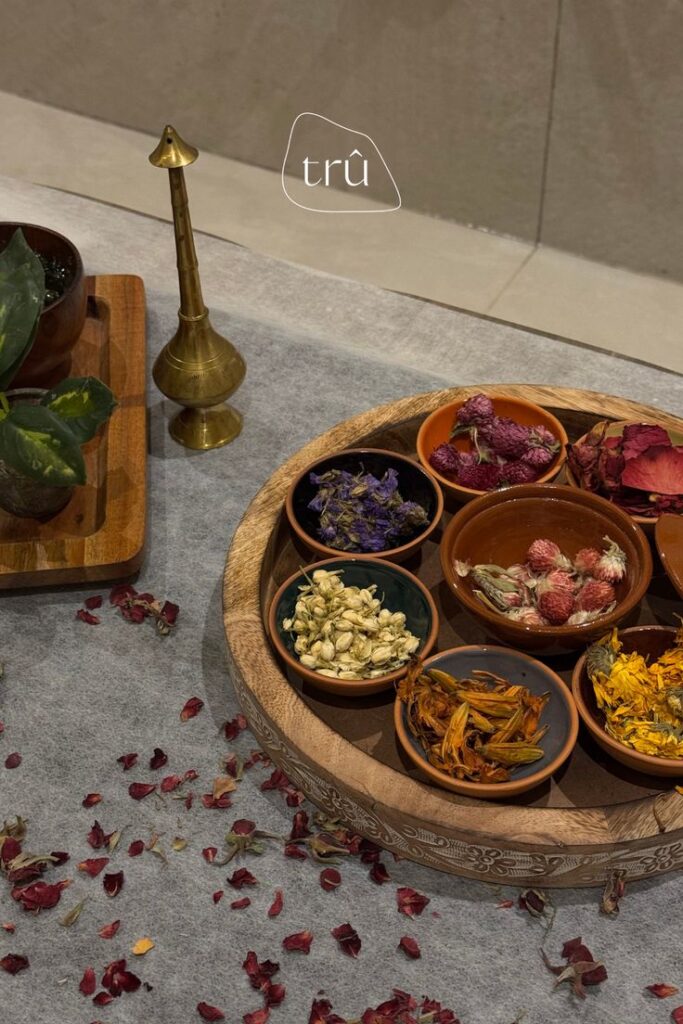 Tru Beauty Lounge _ Dubai Indulge in a Luxurious Moroccan Bath Ritual 🛁✨ Assorted dried botanicals in bowls on carved wooden tray, ideal for natural decor or herbal crafts. Includes petals and leaves. | Sky Rye Design Assorted dried botanicals in bowls on carved wooden tray, ideal for natural decor or herbal crafts. Includes petals and leaves.