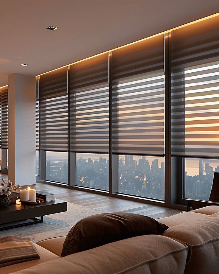 Zebra Blackout Blinds for Modern Homes _ Style + Function Modern living room with floor-to-ceiling windows, city skyline view, soft lighting, and contemporary decor at sunset. | Sky Rye Design Modern living room with floor-to-ceiling windows, city skyline view, soft lighting, and contemporary decor at sunset.