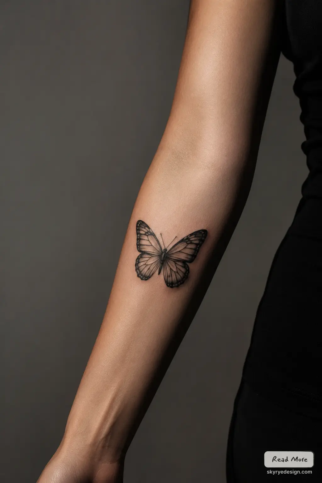 Black-and-gray realistic butterfly tattoo on inner forearm, minimalist monochrome body art