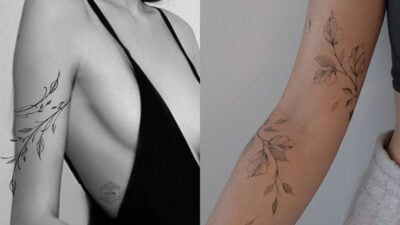 Elegant floral branch tattoos on arms, showcasing intricate leaf designs; one on an exposed arm and another on a sleeved arm.