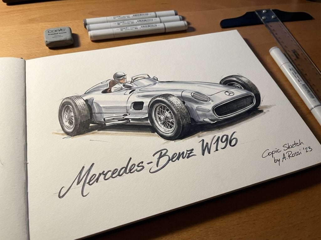 Sketch of a classic Mercedes-Benz W196 race car by A. Rossi, drawn with Copic markers on a wooden desk with art supplies.