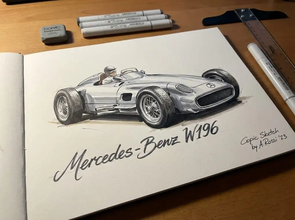 Sketch of a classic Mercedes-Benz W196 race car by A. Rossi, drawn with Copic markers on a wooden desk with art supplies.
