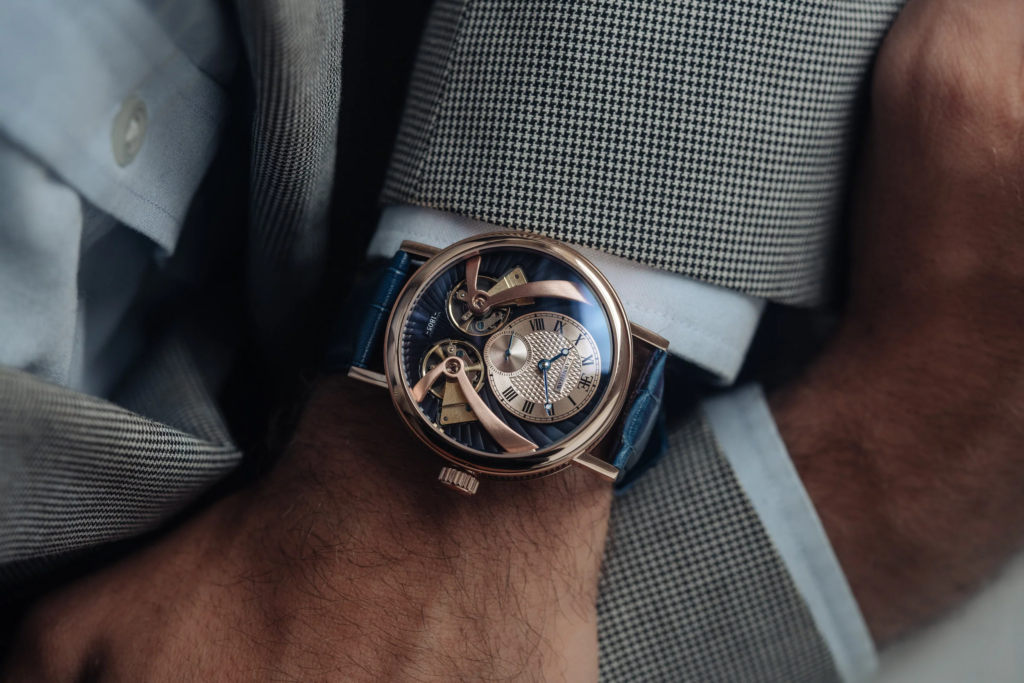 Luxurious watch with intricate gears on a wrist, paired with a checkered suit. Classic elegance and style for the modern gentleman.