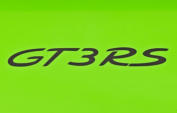 Bold black GT3 RS lettering on a vibrant green background, representing the high-performance sports car model.