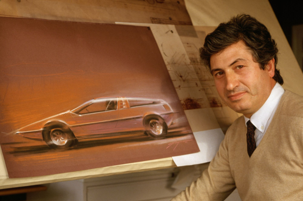 Designer presenting concept sketch of a futuristic car on a brown canvas, highlighting sleek lines and innovative automotive design.