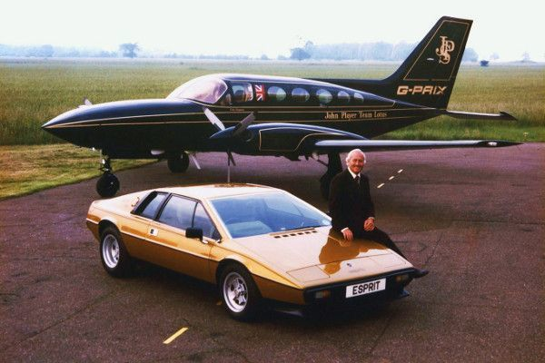 Vintage sports car and private jet on a runway with a person sitting on the car's hood, showcasing luxury travel and classic style.
