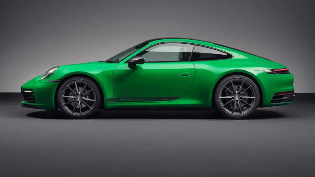 Green sports car side profile on a sleek studio background, showcasing modern design and high-performance features.