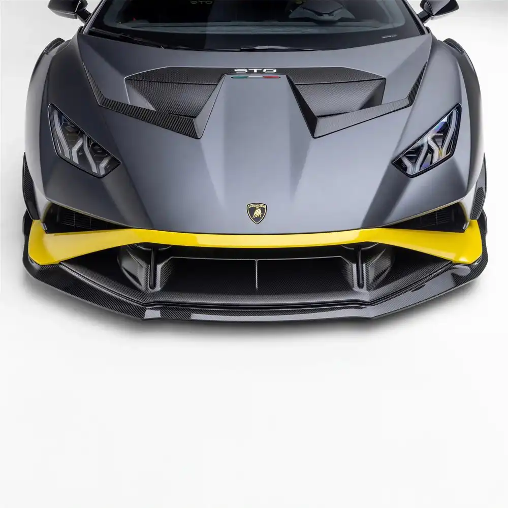 Front view of a sleek, grey Lamborghini with yellow accents, showcasing its sporty design and aerodynamic features.