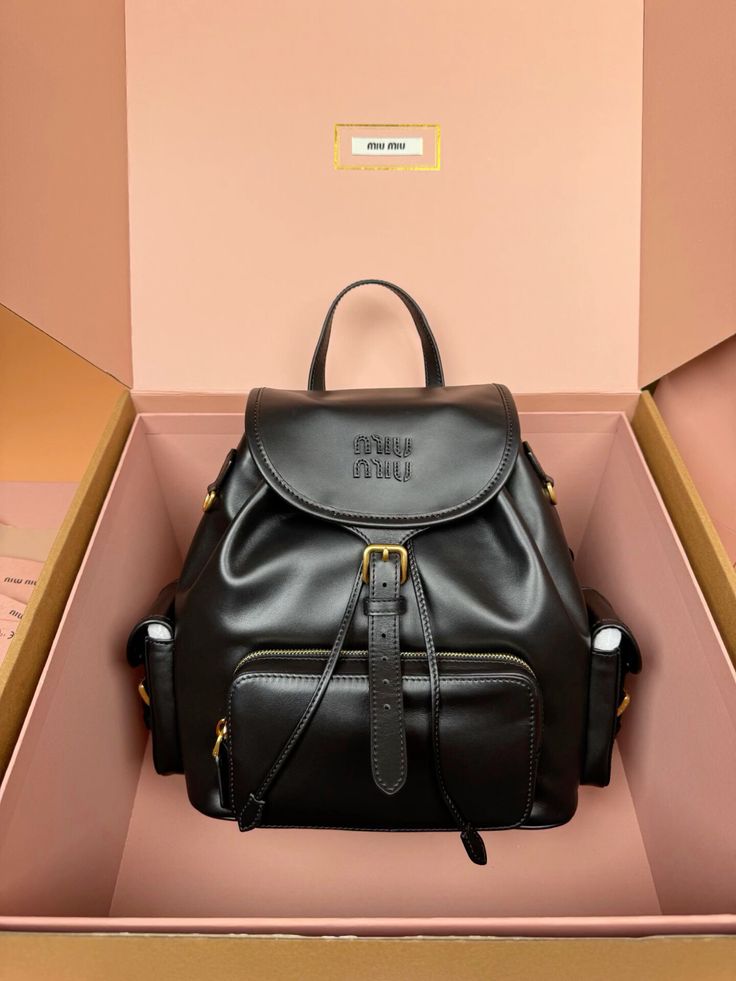miumiu WhatsApp_WeChat_+86 15669556357_🤩Add WhatsApp to get discount_ ⛷What you see what you get_🛩Global shipping _🌇Update every day Elegant black leather backpack with gold accents in a chic pink box. Perfect for fashion-forward individuals looking for style and utility. | Sky Rye Design Elegant black leather backpack with gold accents in a chic pink box. Perfect for fashion-forward individuals looking for style and utility.