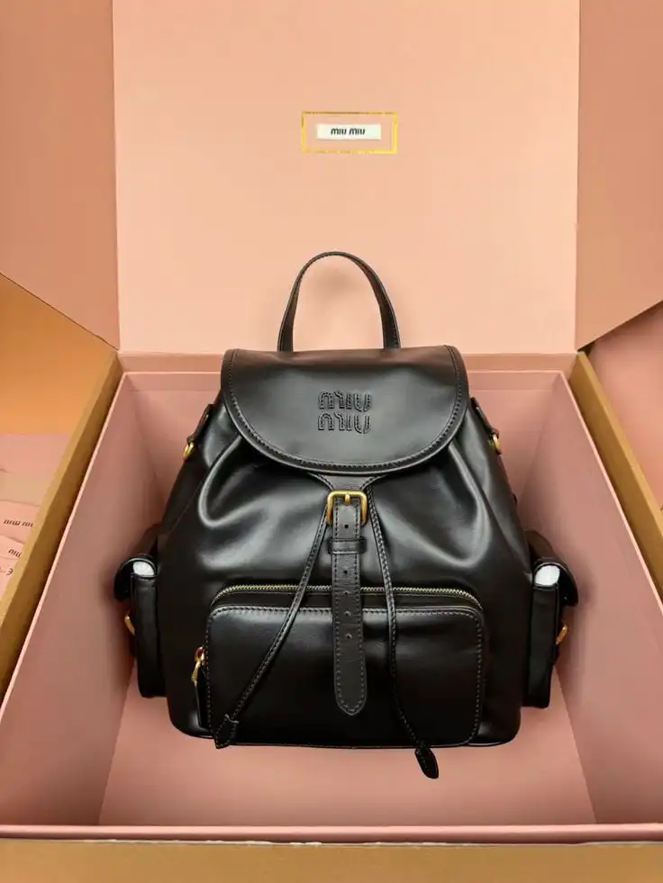 Elegant black leather backpack with gold accents in a chic pink box. Perfect for fashion-forward individuals looking for style and utility.