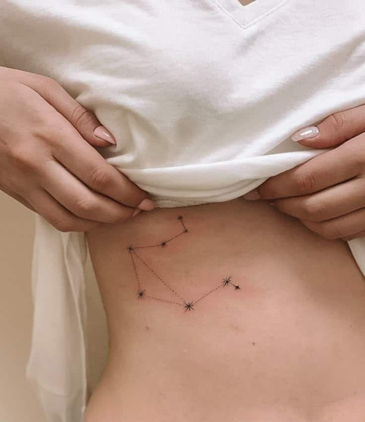 tattoo constellation Libra Minimalist constellation tattoo on the lower abdomen, revealed by a woman lifting her white shirt. | Sky Rye Design Minimalist constellation tattoo on the lower abdomen, revealed by a woman lifting her white shirt.