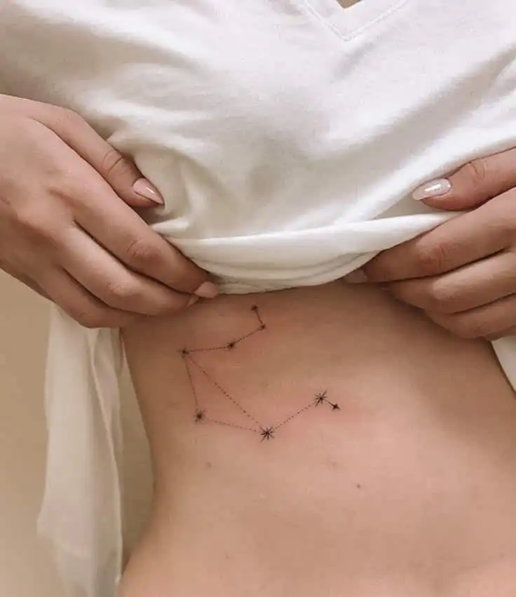 tattoo constellation Libra Minimalist constellation tattoo on the lower abdomen, revealed by a woman lifting her white shirt. | Sky Rye Design Minimalist constellation tattoo on the lower abdomen, revealed by a woman lifting her white shirt.