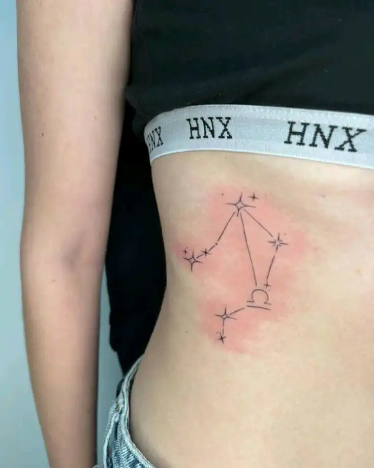 tattoo Libra constellation tattoo on a person's side, featuring delicate star designs and intricate linework, set against a skin backdrop. | Sky Rye Design Libra constellation tattoo on a person's side, featuring delicate star designs and intricate linework, set against a skin backdrop.