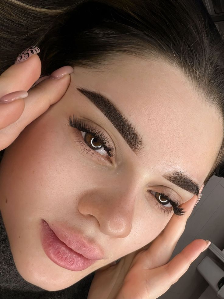 Перманентные брови_ Натуральная ретушь для идеального образа ✨ Close-up of a woman's face with well-groomed eyebrows and eyelashes, highlighting beauty and skincare. | Sky Rye Design Close-up of a woman's face with well-groomed eyebrows and eyelashes, highlighting beauty and skincare.