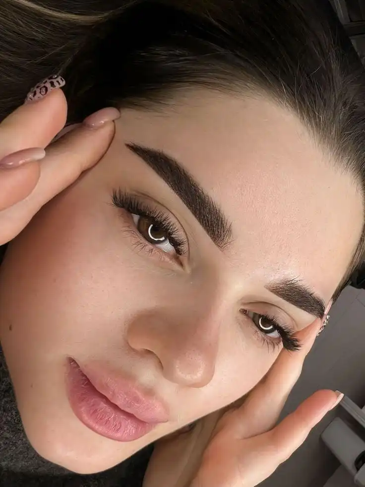 Перманентные брови_ Натуральная ретушь для идеального образа ✨ Close-up of a woman's face with well-groomed eyebrows and eyelashes, highlighting beauty and skincare. | Sky Rye Design Close-up of a woman's face with well-groomed eyebrows and eyelashes, highlighting beauty and skincare.
