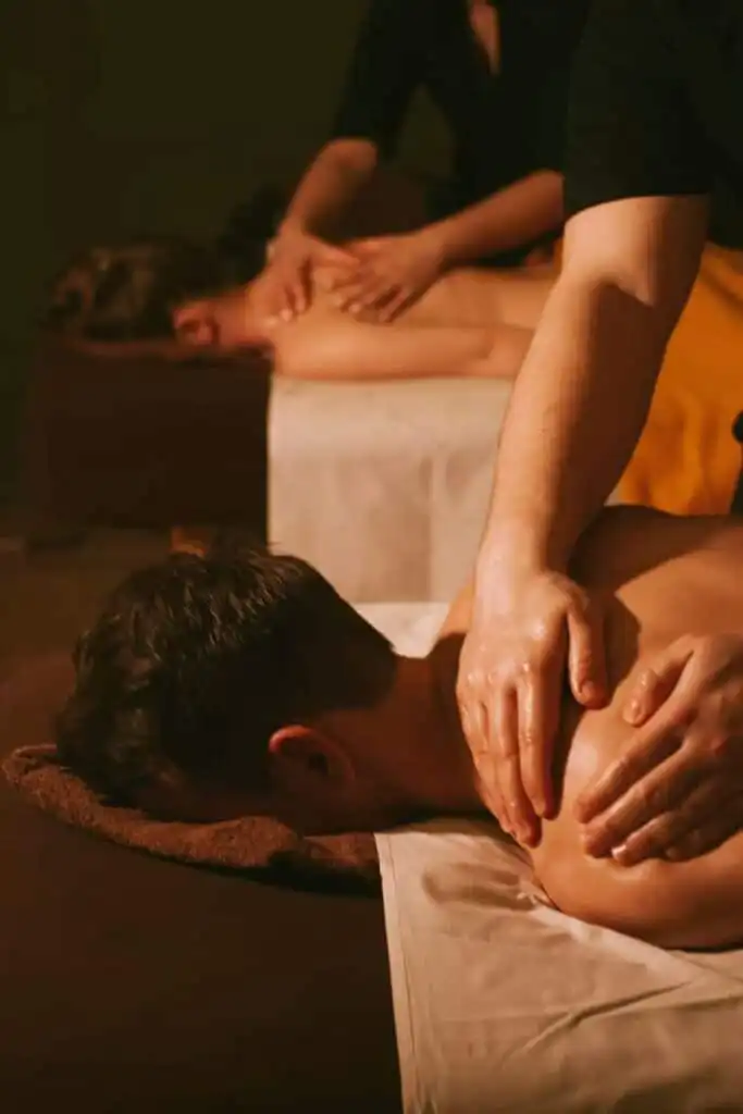 Couple enjoying a relaxing back massage at a spa, focusing on tranquility and wellness. Perfect setting for stress relief and rejuvenation.