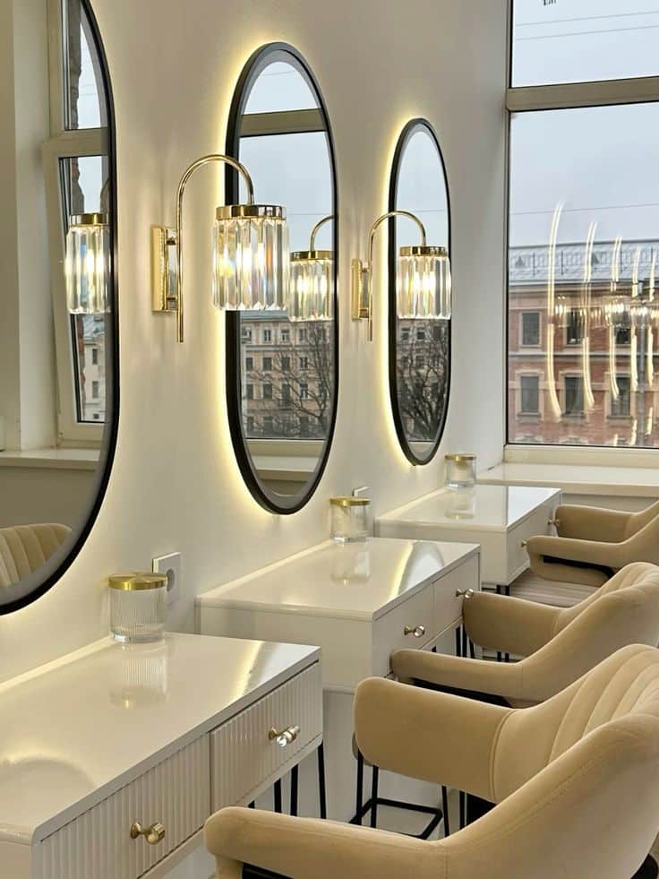 рабочее место визажиста Modern salon interior with elegant oval mirrors, stylish lighting, and beige chairs in front of makeup stations, creating a chic atmosphere. | Sky Rye Design Modern salon interior with elegant oval mirrors, stylish lighting, and beige chairs in front of makeup stations, creating a chic atmosphere.