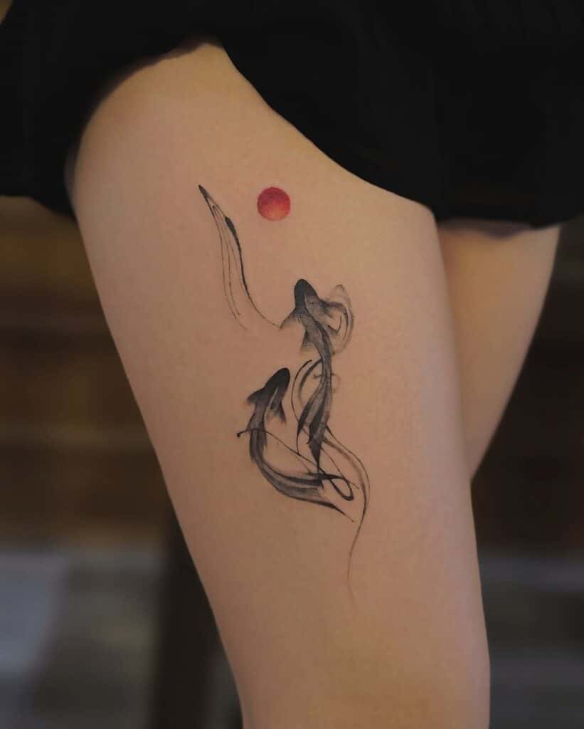 Minimalist thigh koi tattoo: two black watercolor koi fish in brushstroke style with a small red sun, Asian-inspired body art