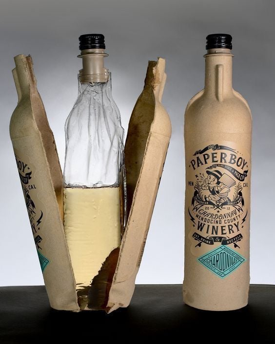Chardonnay wine bottle in kraft paper sleeve, one sleeve peeled back to reveal glass bottle - eco-friendly packaging.