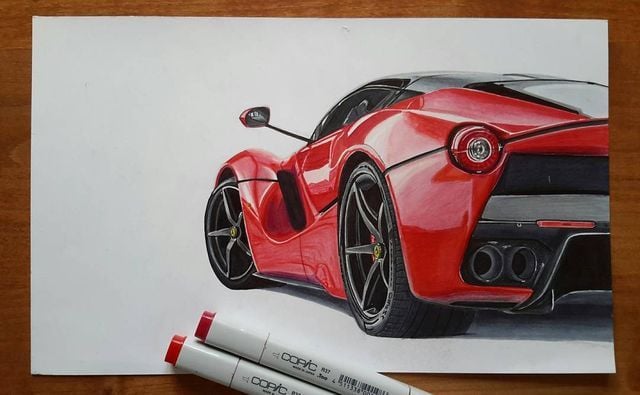 Realistic red sports car drawing on paper, rear three-quarter view with Copic markers in the foreground.