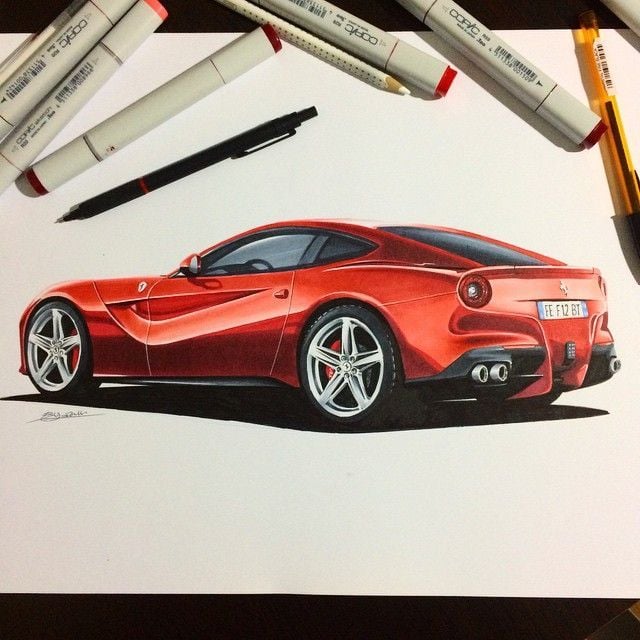 Red sports car marker illustration in rear three-quarter view on paper, surrounded by markers and pens — automotive concept art sketch