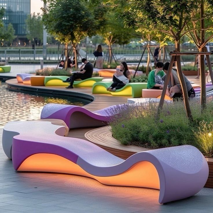 b05433ddc575558e3741b57937345243 Modern curved LED-lit colorful benches in waterfront urban park with people relaxing by trees and pond | Sky Rye Design Modern curved LED-lit colorful benches in waterfront urban park with people relaxing by trees and pond
