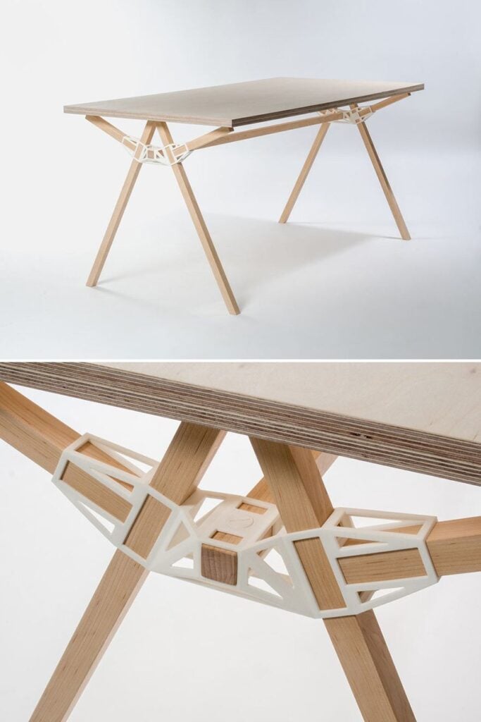 Minimalist modern wooden table with plywood top, angled trestle legs and white 3D-printed lattice connectors