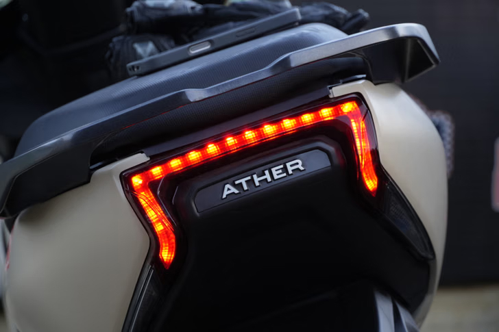 Close-up of Ather electric scooter rear with illuminated red LED taillight and ATHER logo.