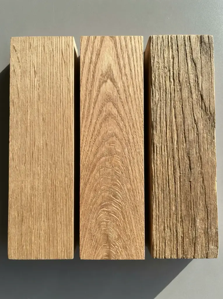 Three oak planks showing smooth, cathedral and reclaimed weathered wood textures — wood grain samples for flooring