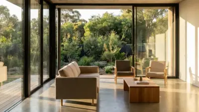 Modern living room with floor-to-ceiling glass, beige sofa, wooden coffee table and garden view in natural light