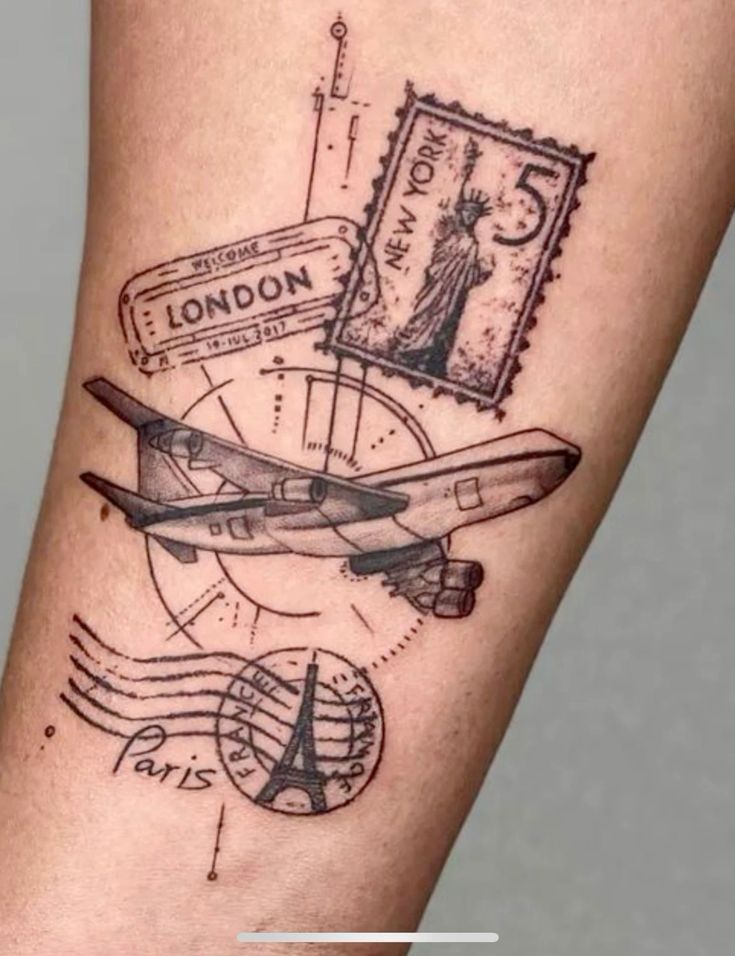 Travel-themed forearm tattoo of airplane with London, New York and Paris stamps/postmarks (Eiffel Tower, Statue of Liberty)