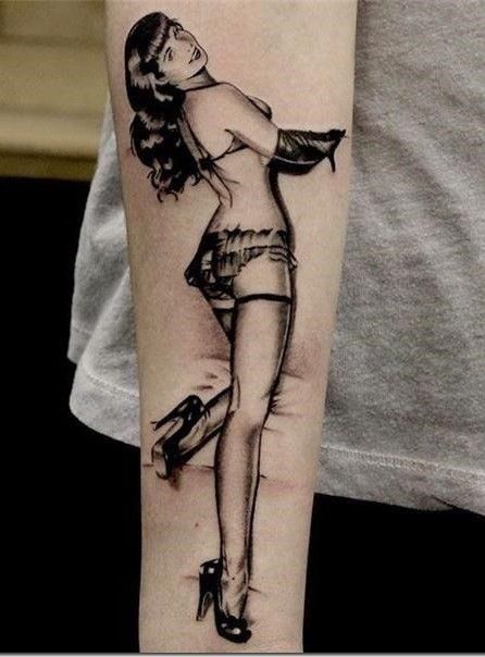 Black-and-gray vintage pin-up girl forearm tattoo, realistic style with high heels, stockings and retro lingerie