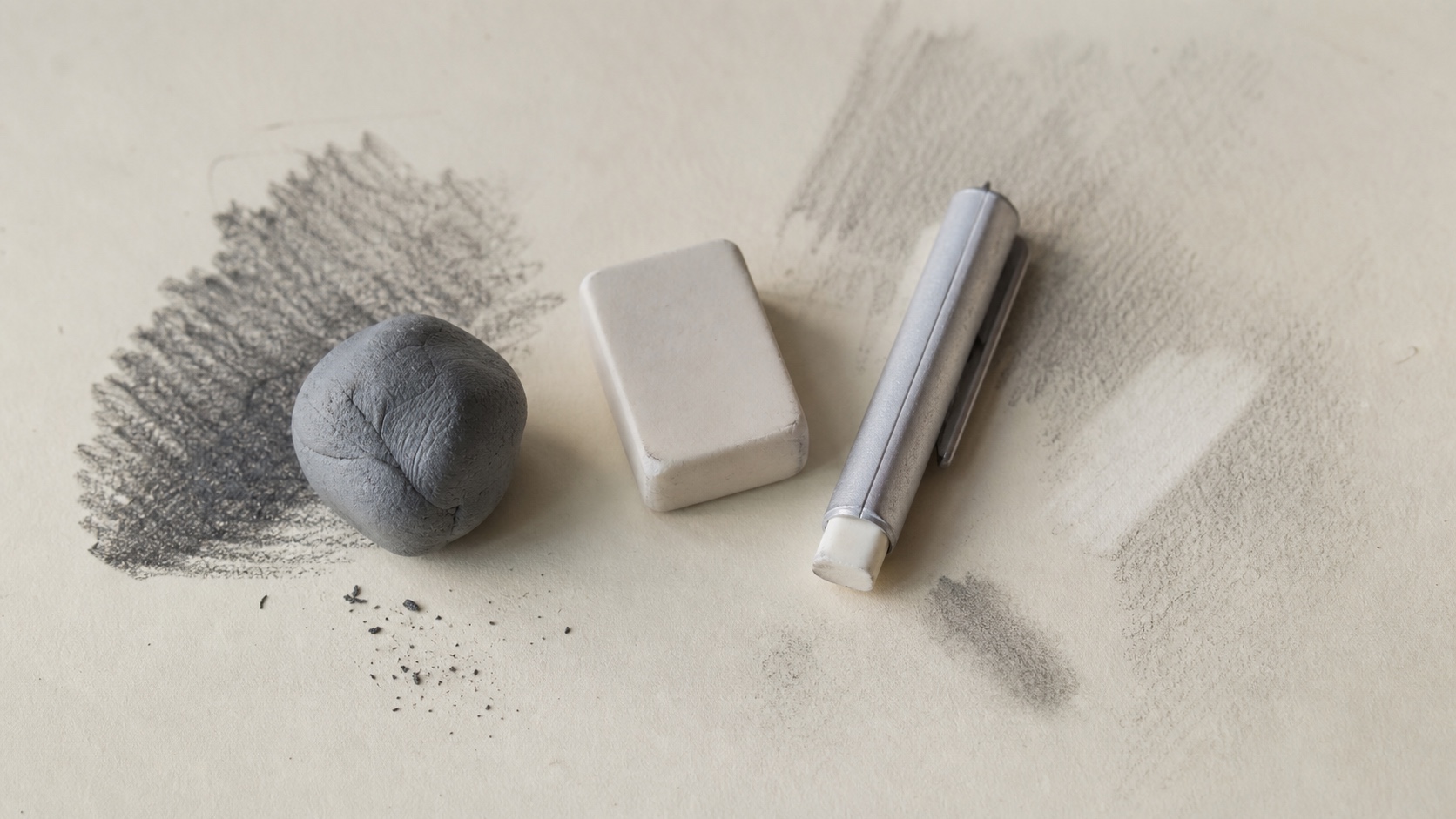 Artist Erasers for Graphite Corrections Kneaded eraser, white plastic eraser, and precision eraser on graphite-marked drawing paper. | Sky Rye Design Kneaded eraser, white plastic eraser, and precision eraser on graphite-marked drawing paper.