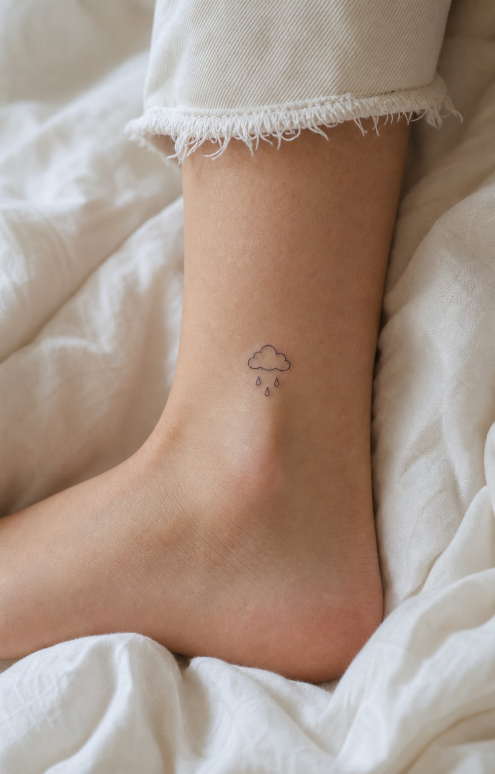Dreamy cloud raindrops ankle tattoo Dreamy cloud and raindrops ankle tattoo in small fine-line black ink. | Sky Rye Design Dreamy cloud and raindrops ankle tattoo in small fine-line black ink.