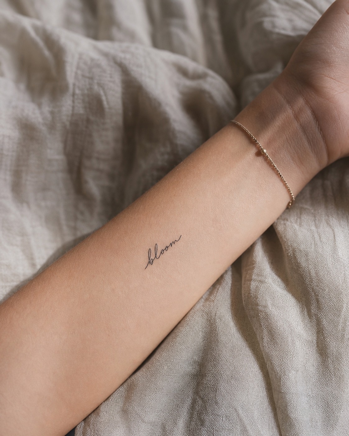 Fine line script bloom tattoo Fine-line script tattoo reading bloom on the inner forearm in a delicate handwritten style. | Sky Rye Design Fine-line script tattoo reading bloom on the inner forearm in a delicate handwritten style.