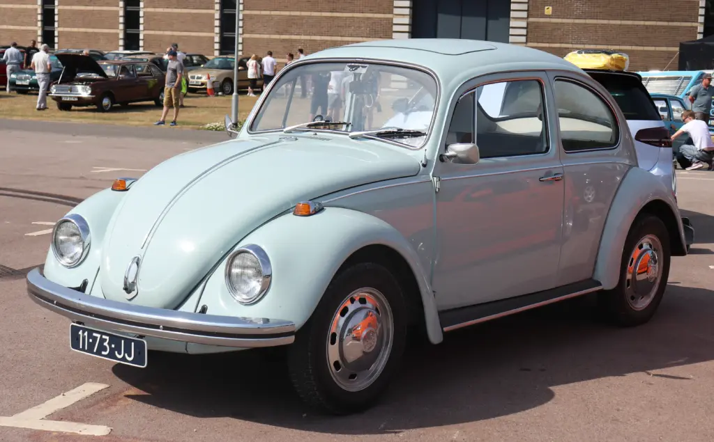1969_Volkswagen_Beetle_Dutch_Reg Light blue vintage Volkswagen Beetle parked at outdoor classic car show with people and cars in background | Sky Rye Design Light blue vintage Volkswagen Beetle parked at outdoor classic car show with people and cars in background