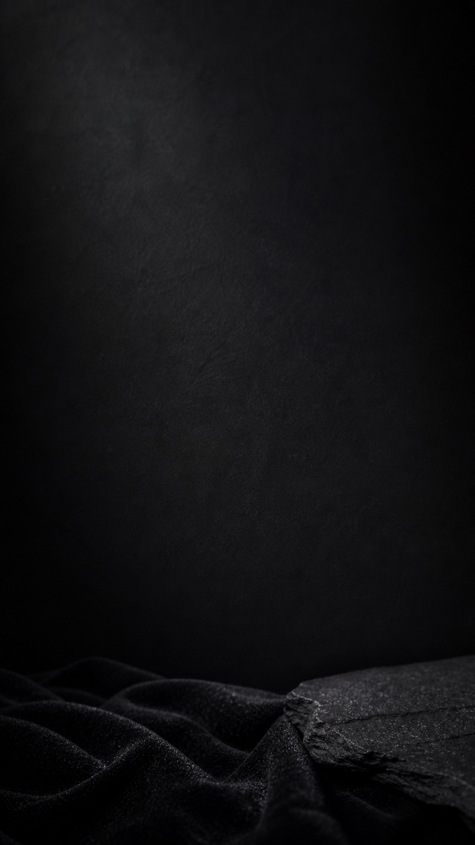 iPhone black wallpaper OLED texture Matte black OLED-friendly iPhone wallpaper with subtle graphite texture and deep negative space. | Sky Rye Design Matte black OLED-friendly iPhone wallpaper with subtle graphite texture and deep negative space.
