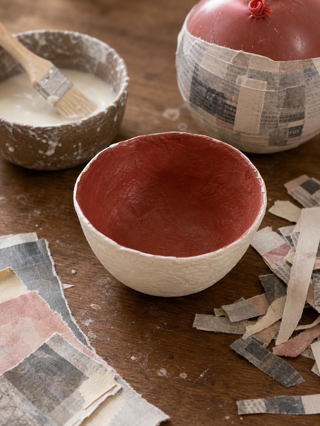 Paper mache bowl craft with paper strips and paint