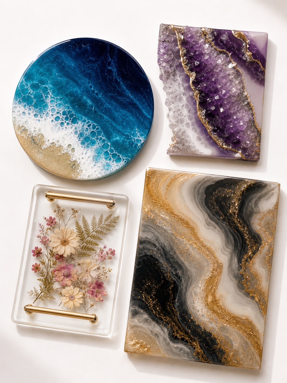 Flat lay of finished resin art project ideas including an ocean coaster, geode panel, flower tray and gold swirl pour.