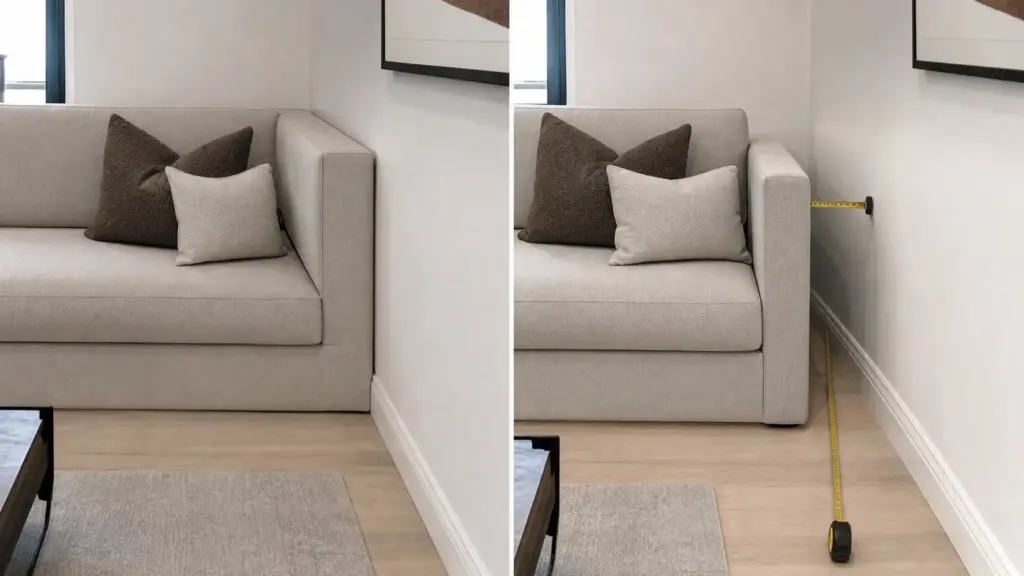 Beige modern sofa with brown and cream throw pillows and a tape measure checking gap between sofa and wall in living room