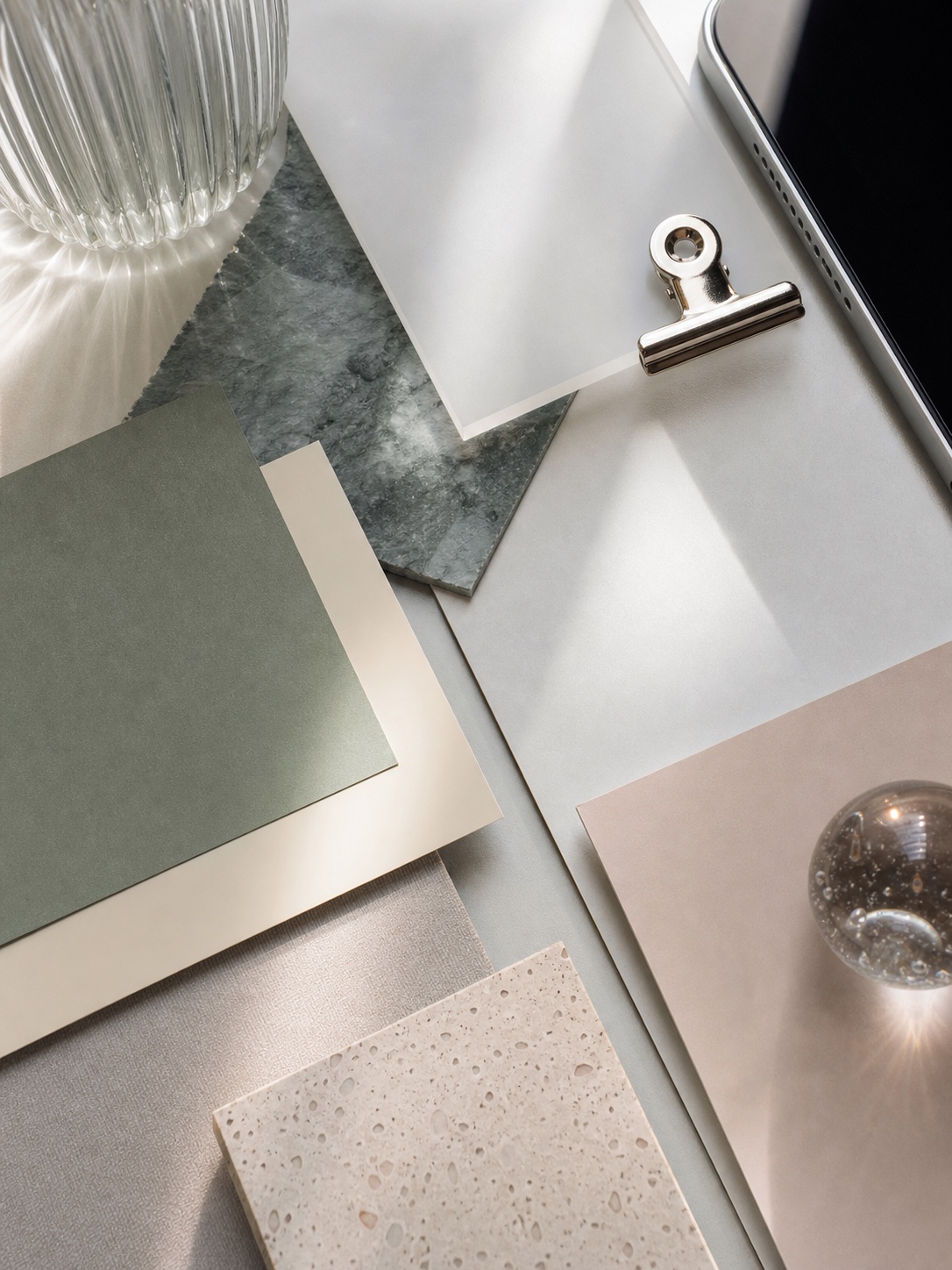 iPad wallpaper aesthetic cover - Popular Styles and Trends Moodboard of color swatches and material samples on a light desk, with a metal clipboard clip and a glass vase nearby. | Sky Rye Design Aesthetic iPad wallpaper cover for popular styles and trends, with a clean modern composition and no text.